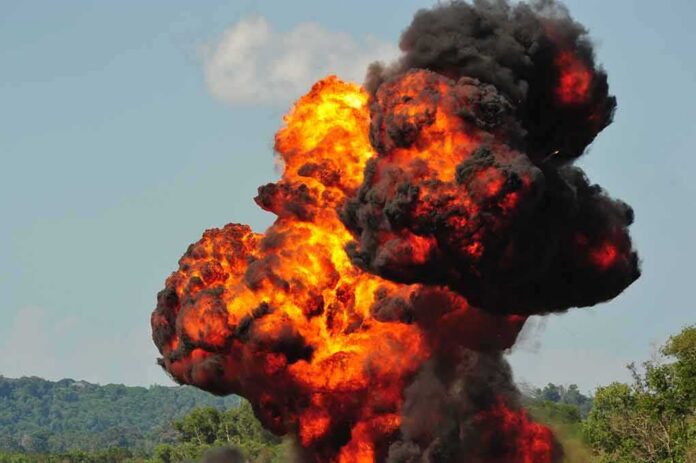 shutterstock_1043936473 Fireball explosion with thick black smoke in open landscape
