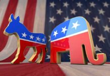 Unhinged Dem Candidate’s WILD T.V Appearance Goes Viral Democratic donkey and Republican elephant symbols on American flag backdrop