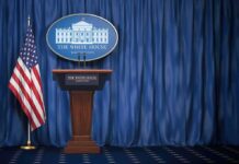 White House Releases HILARIOUS Video Of Trump Bashing CNN White House press briefing podium with U.S. flag and blue curtain