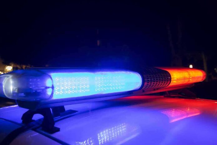 shutterstock_1168252924-2 Police car light bar flashing blue and red at night