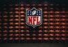 Outrage – NFL Performer Changes Anthem Lyrics! NFL shield logo over wall of footballs