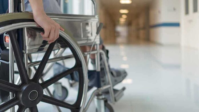 shutterstock_1295143738 Wheelchair in hospital corridor