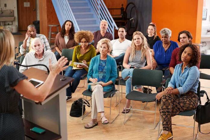 Audience listening to a speaker at a community meeting