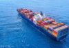 Container ship carrying colorful cargo containers at sea