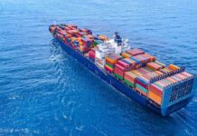 Container ship carrying colorful cargo containers at sea