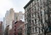 Baby Thrown From Balcony Clinging to Life Street view of urban apartment buildings with fire escapes