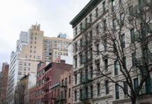 Street view of urban apartment buildings with fire escapes