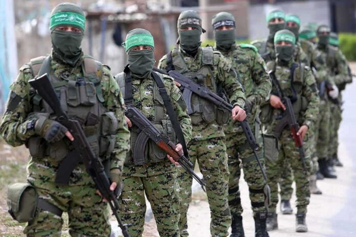 Armed men in camouflage uniforms standing in a line