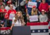 Girls SKIP Class For Trump Rally – Teachers APPROVE! Walter Jones speaks at a rally podium with a crowd and flags in the background