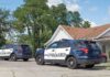 Father Stabs 17-Year-Old Twins to Death Before Taking His Own Life Two police SUVs parked near a suburban house
