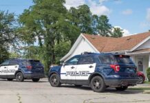 Father Stabs 17-Year-Old Twins to Death Before Taking His Own Life Two police SUVs parked near a suburban house