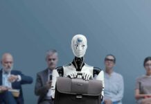 Robot Sex Assault Probe Shocks Cops Jan-Peter Nikiferow seated with a humanoid robot holding a briefcase in front