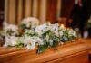 Coffin with white floral arrangement