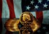 Gold Nude Trump Stuns Onlookers Gold commemorative coins stacked with a profile portrait in front of a U.S. flag