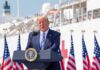 Trump Praises WNBA Star – Calls Her Beautiful Donald Trump speaking at a podium with American flags and a ship in the background