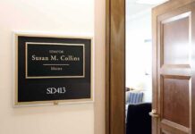 Dem Candidate Stumbles in Debate, Collins Smokes Him on His Record Office door sign in a hallway