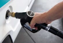 Russian Diesel Gambit Sparks Legal Firestorm A hand holding a diesel fuel nozzle while refueling a vehicle
